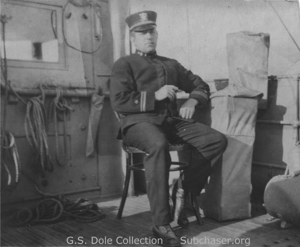 CO George S. Dole sitting on bridge wing.