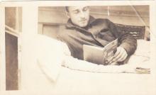 Crewman on chaser reading "Wireless Telegraphy" book