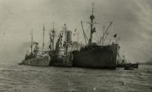 USS Penguin marked PD and another minesweeper alongside USS Black Hawk