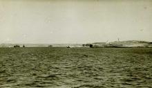 Malta SetChaser skiff, with crewmen in raincoats.